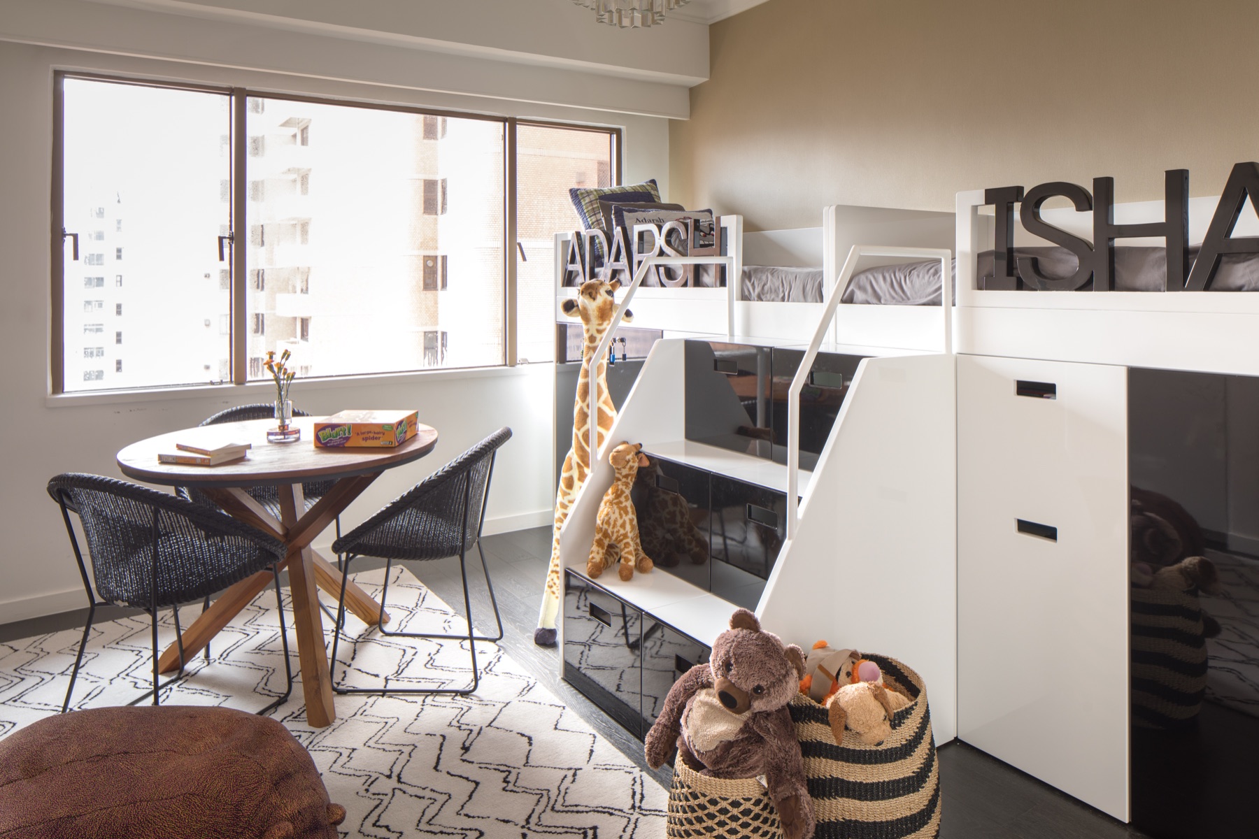 Bedroom with bunk beds, a window desk, patterned rug and beanbag in The Story of Us